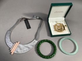 A Christian Dior Parfums gilt logo brooch, two jade effect bangles and a Dansk Smykkekunst necklace