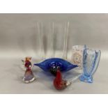 A collection of art glass comprising three slender vases, a twin handled blue vase of wrythen