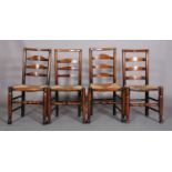 FOUR EARLY 19TH CENTURY LANCASHIRE ASH LADDER BACK CHAIRS, the shaped top rails and curved bars