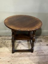 A Titchmarsh and Goodwin oak occasional table, circular outline on turned legs joined by a square