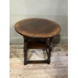 A Titchmarsh and Goodwin oak occasional table, circular outline on turned legs joined by a square