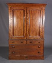 A 19th century mahogany clothes press, having a moulded cornice above two indented panel doors,
