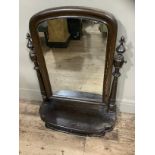 A mid 19th century toilet mirror, arched glass on turned supports with a drawer to the platform