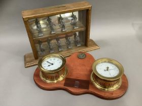 A brass cased clock and barometer set, the back board previously with presentation plaques