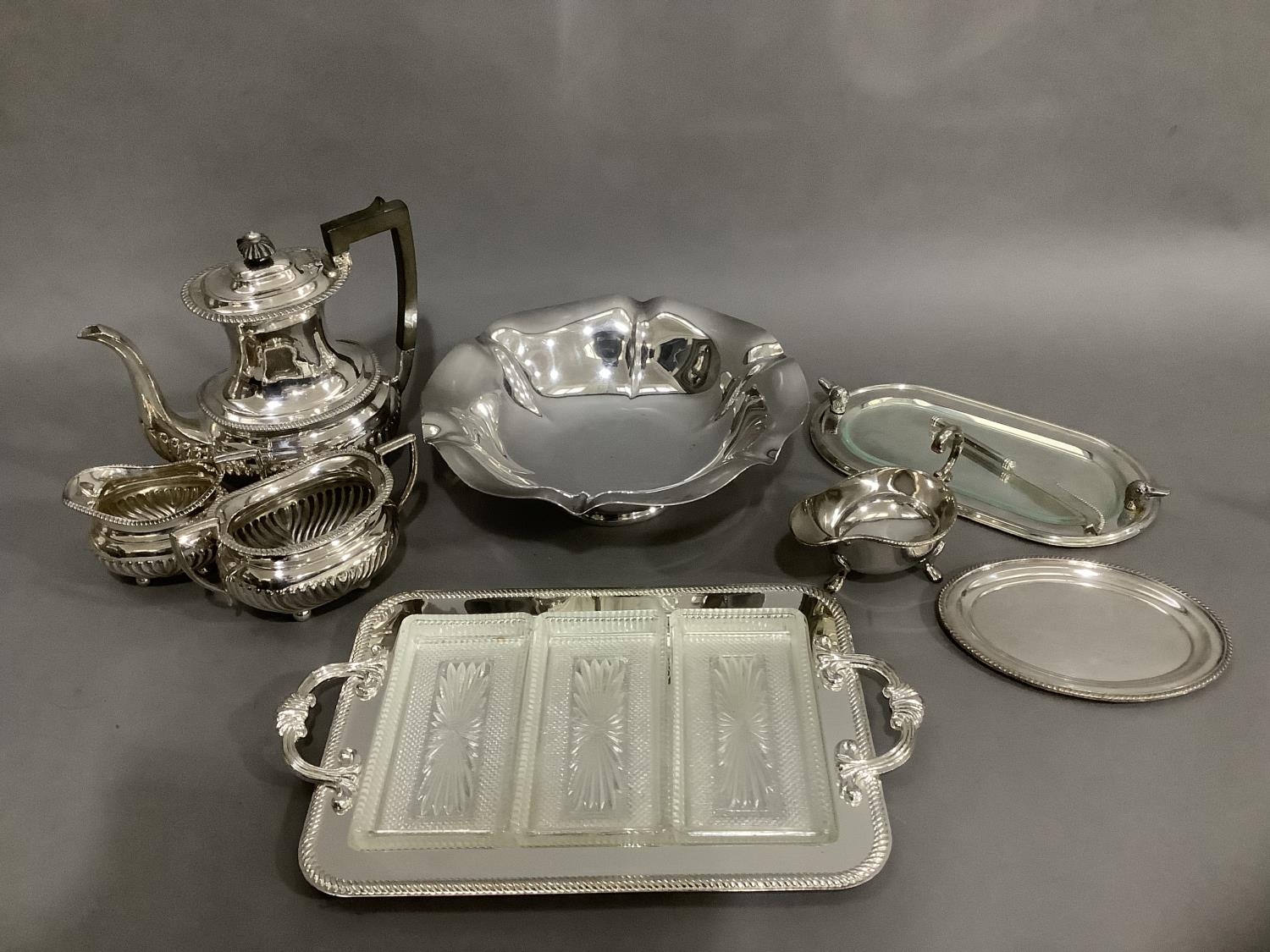 Silver plated silverware, including a three piece coffee service of half reeded design, comprising