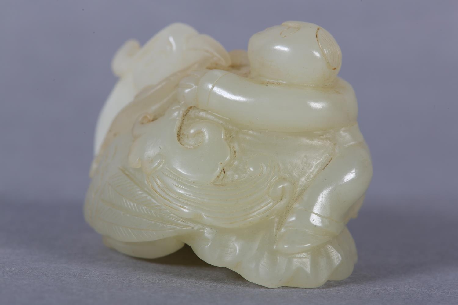 A Chinese jade carving of a boy climbing upon the back of a phoenix with its head turned backwards - Image 7 of 8