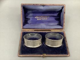 A pair of Queen Elizabeth II silver napkin rings Birmingham 1962 for Crisford and Norris Ltd, engine