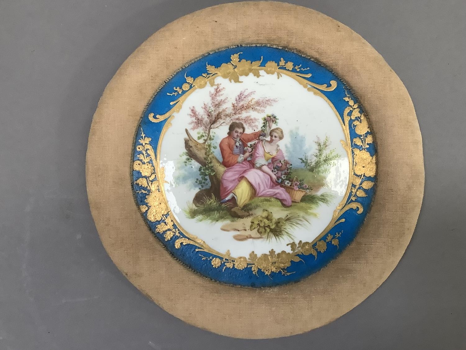 A Sevres style porcelain plaque, painted with a romantic scene of a lovers in a landscape within a