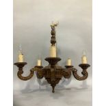 An early to mid 20th Century polished wood five light pendant light fitting with faux bois finish,