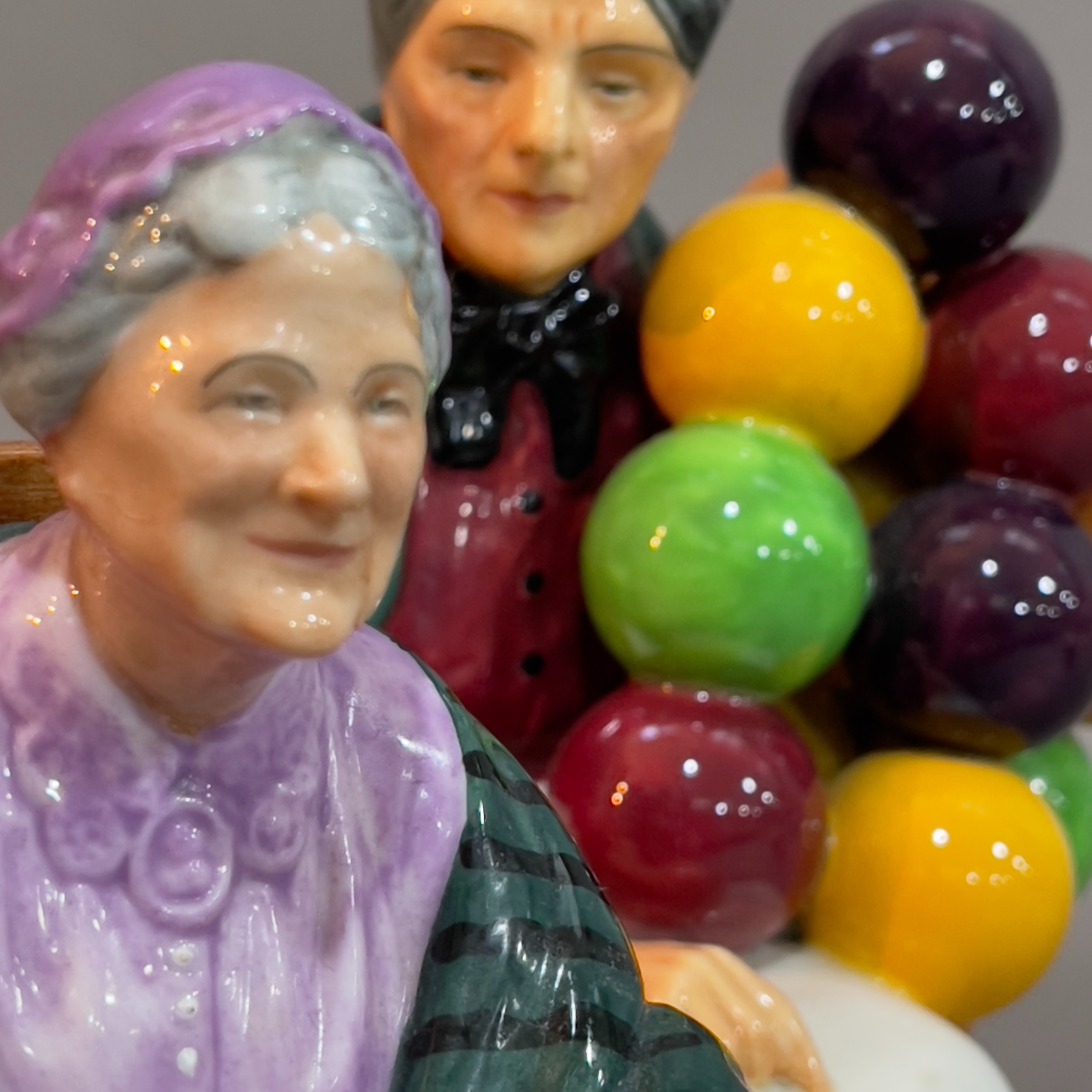 A Royal Doulton ' The Old Balloon Seller' 18cm high and 'The Family Album' figures - Image 2 of 2