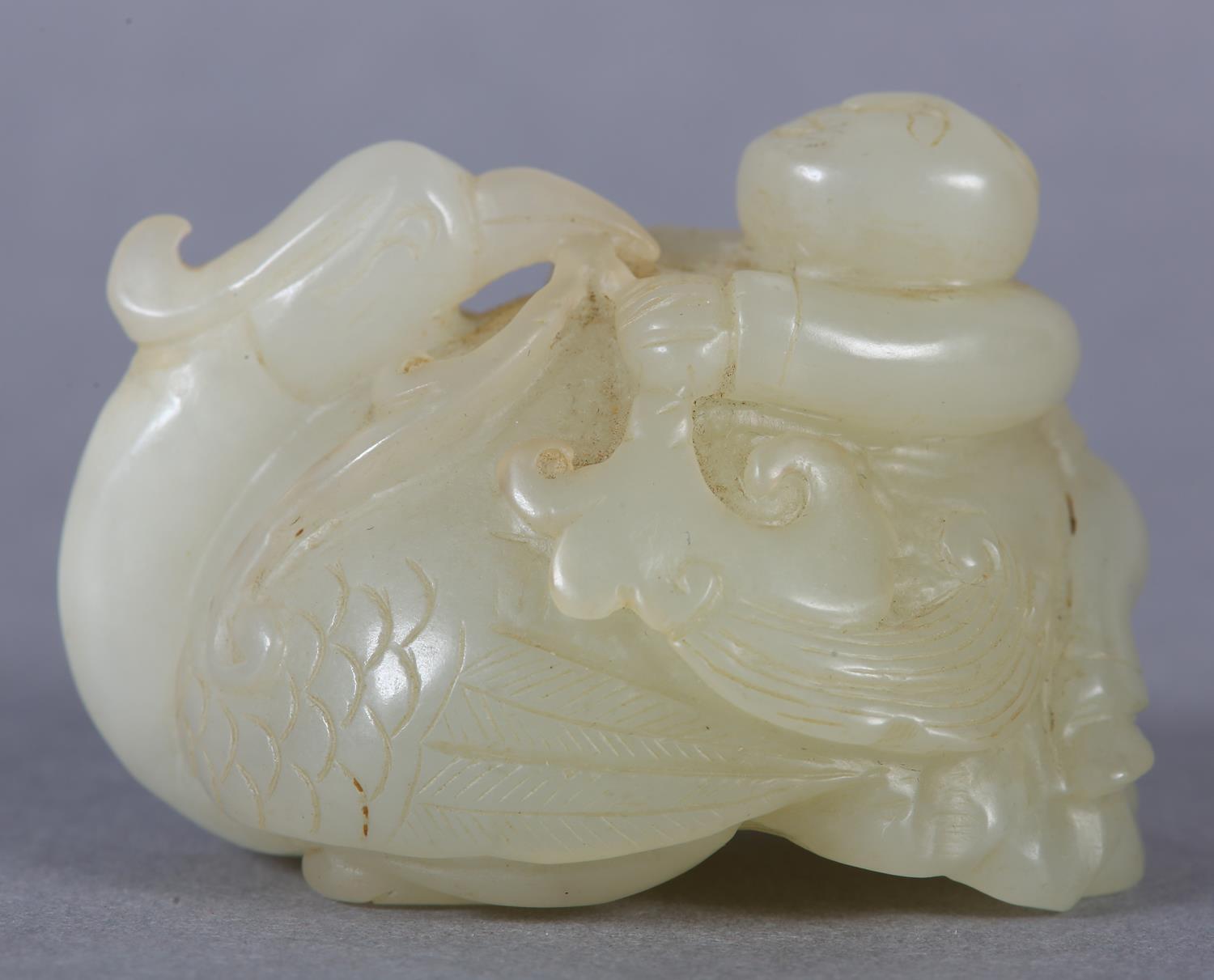 A Chinese jade carving of a boy climbing upon the back of a phoenix with its head turned backwards - Image 6 of 8