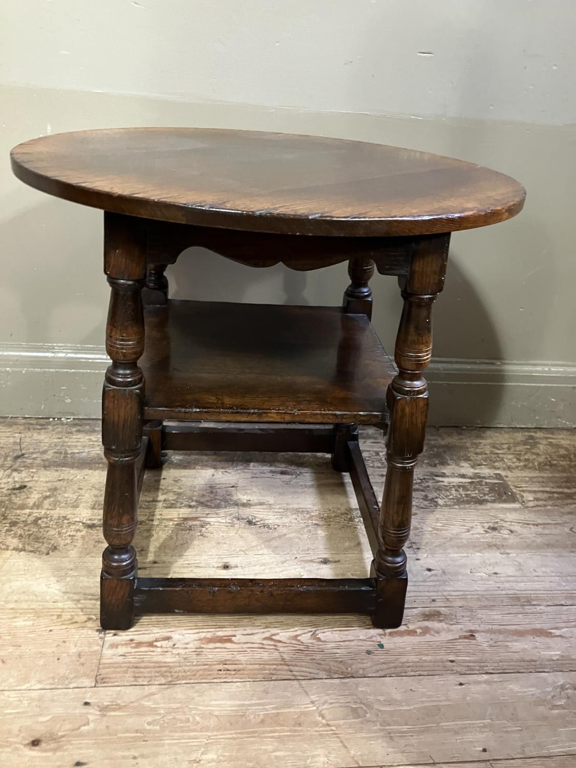 A Titchmarsh and Goodwin oak occasional table, circular outline on turned legs joined by a square - Image 3 of 3