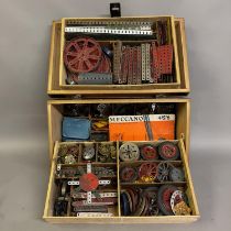 A quantity of Meccano in a three-tier wooden case, including a large number of brass gears,