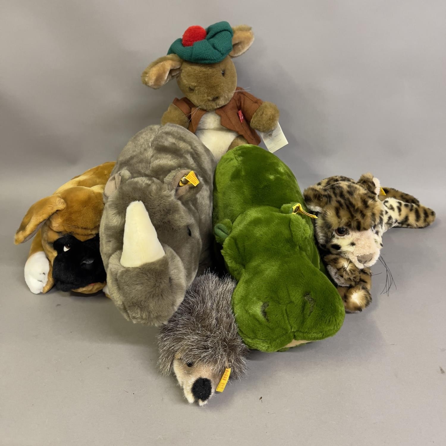 A collection of six Steiff animals including cheetah, Boxer dog, green hippo, Rhinoceros, small