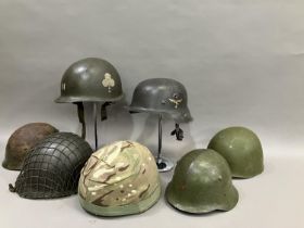 A group of six WWII and later steel helmets including a Belgian example; USA, and a reproduction