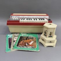 A Winfield 2444 Electric Reed Organ and three Winfield music books, along with a Selcol musical