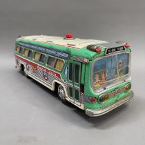 A 1950s Yonezawa ‘Avenue Coach’ tin plate model measuring 42cm long, being battery operated and in