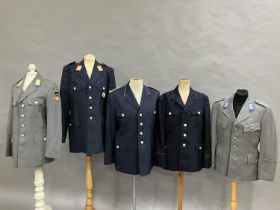 Three West German Luftwaffe dark blue tunics and two army tunics, post war (5)