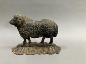 A Victorian cast iron door stop in the form of a sheep, 25cm wide x 19cm high