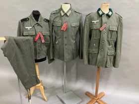 A reproduction WWII style German battle dress blouse with Wesmachtsadler eagle and pair of