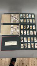 Three Wills' cigarette card albums containing a mixture of cards and two Churchman's albums with