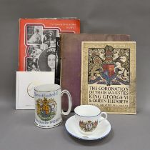 A collection of commemorative memorabilia, including a souvenir programme from the coronation of