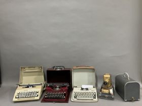 An Olympia Splendid 66 portable typewriter, a Royal portable typewriter and a Smith-Corona Courier