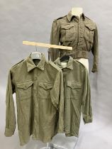 A British Army 1951 battle dress with REME insignia together with two later wool army shirts