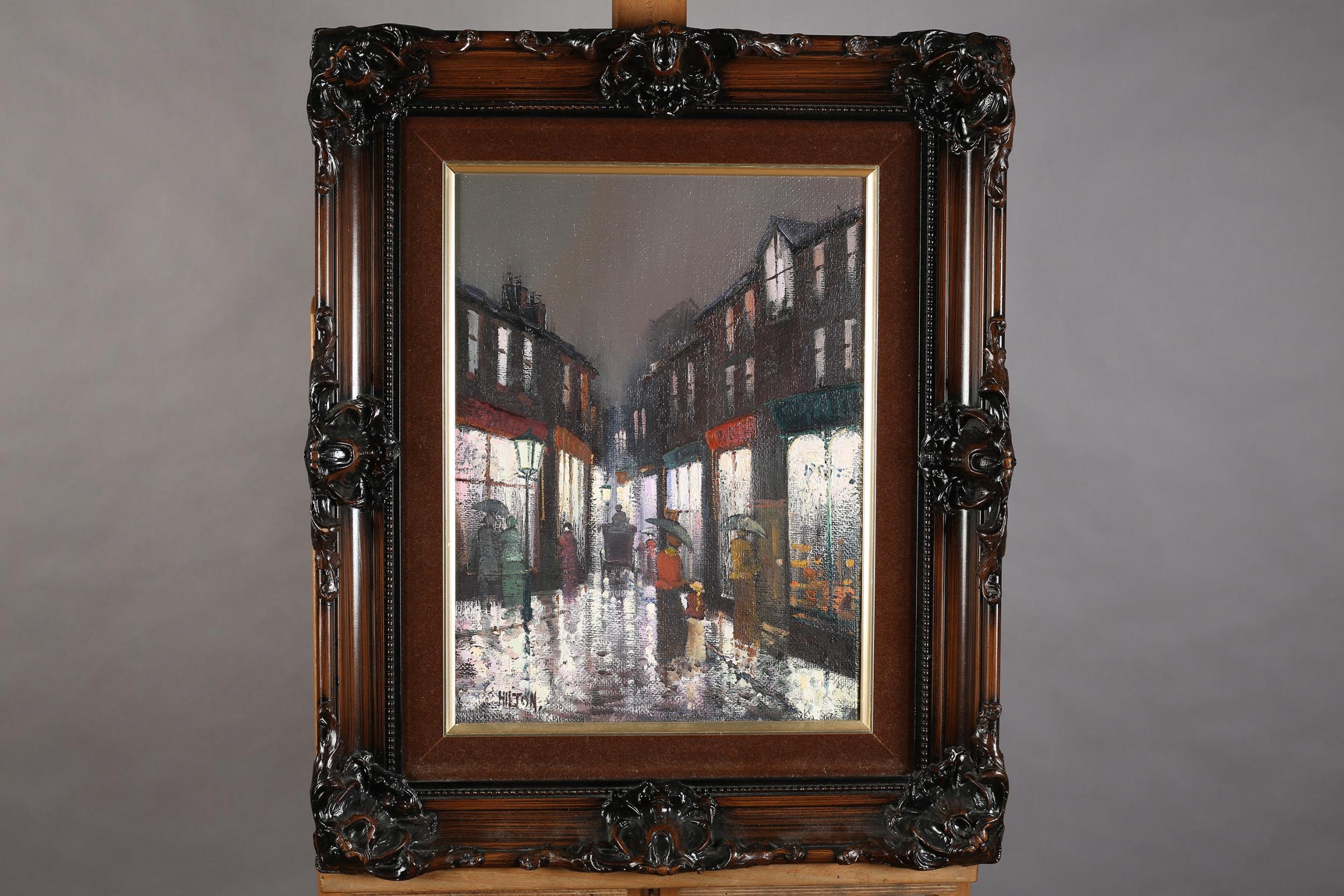 ARR Barry Hilton (b 1941), Edwardian street scene with figures on a rainy night, oil on canvas,