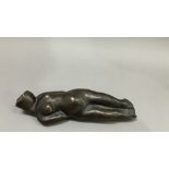 British School mid 20th century, A bronze female nude figure, reclining, 22cm long