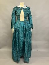 An 1870’s watered silk two piece costume, a vibrant green with floral design, the skirt with machine