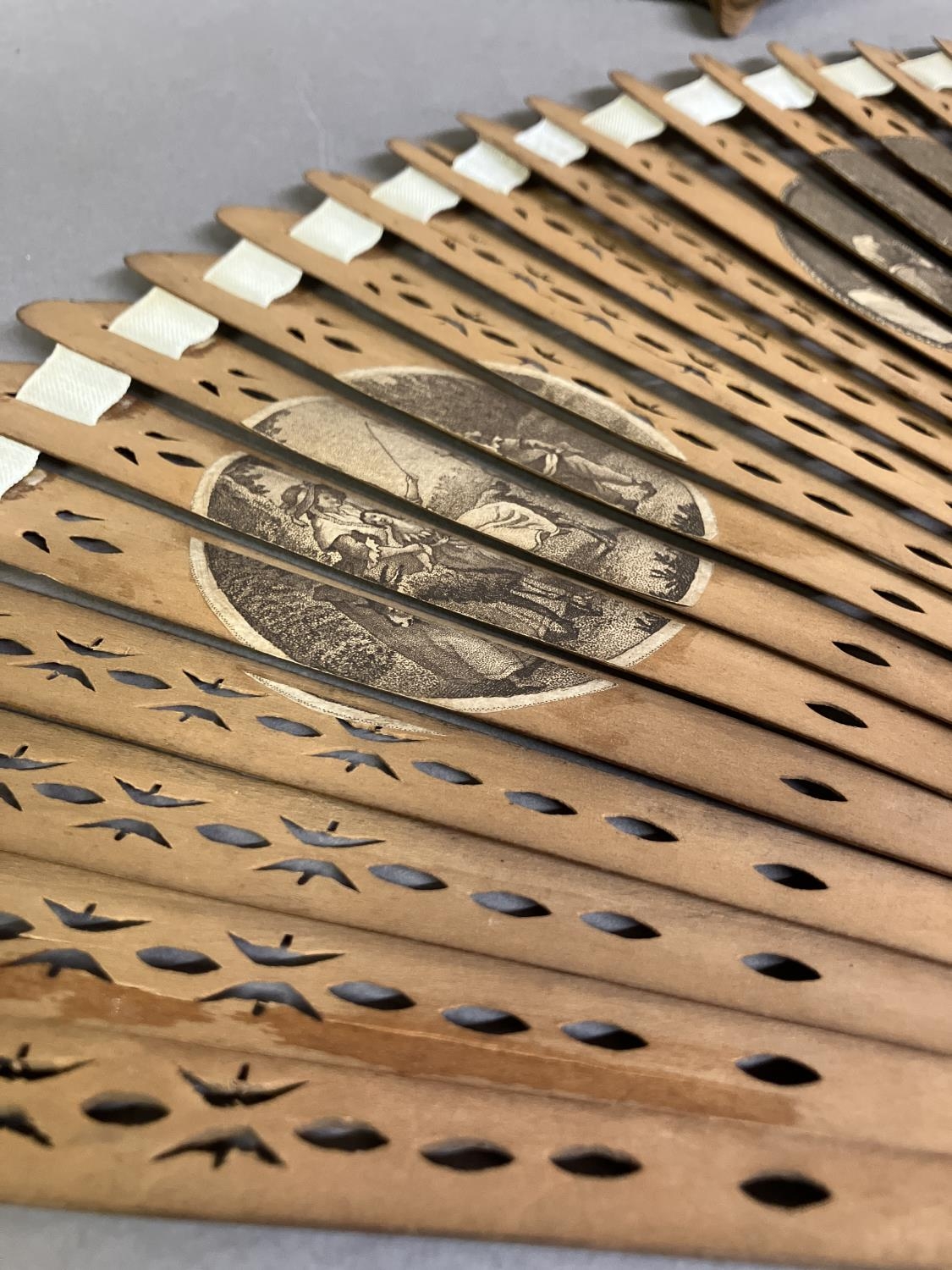 Two late 18th century wood fans, the first a brisé with rounded tips, pierced, with applied - Image 4 of 7