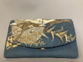 A 19th century Japanese purse or pouch, in teal wool, applied with a sun or moon in beige wool,