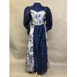 C 1895/1900, a woven silk grey two-piece costume with navy blue flowers, the boned bodice with front