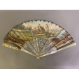 An 18th century mother of pearl fan with leaf of painted silk, showing a man seated on a throne, a