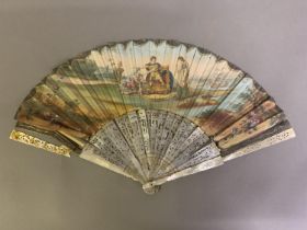 An 18th century mother of pearl fan with leaf of painted silk, showing a man seated on a throne, a