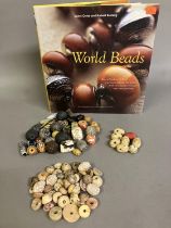 Trade beads: a good selection of beads, various sizes and shapes, many black or grey, carved, others