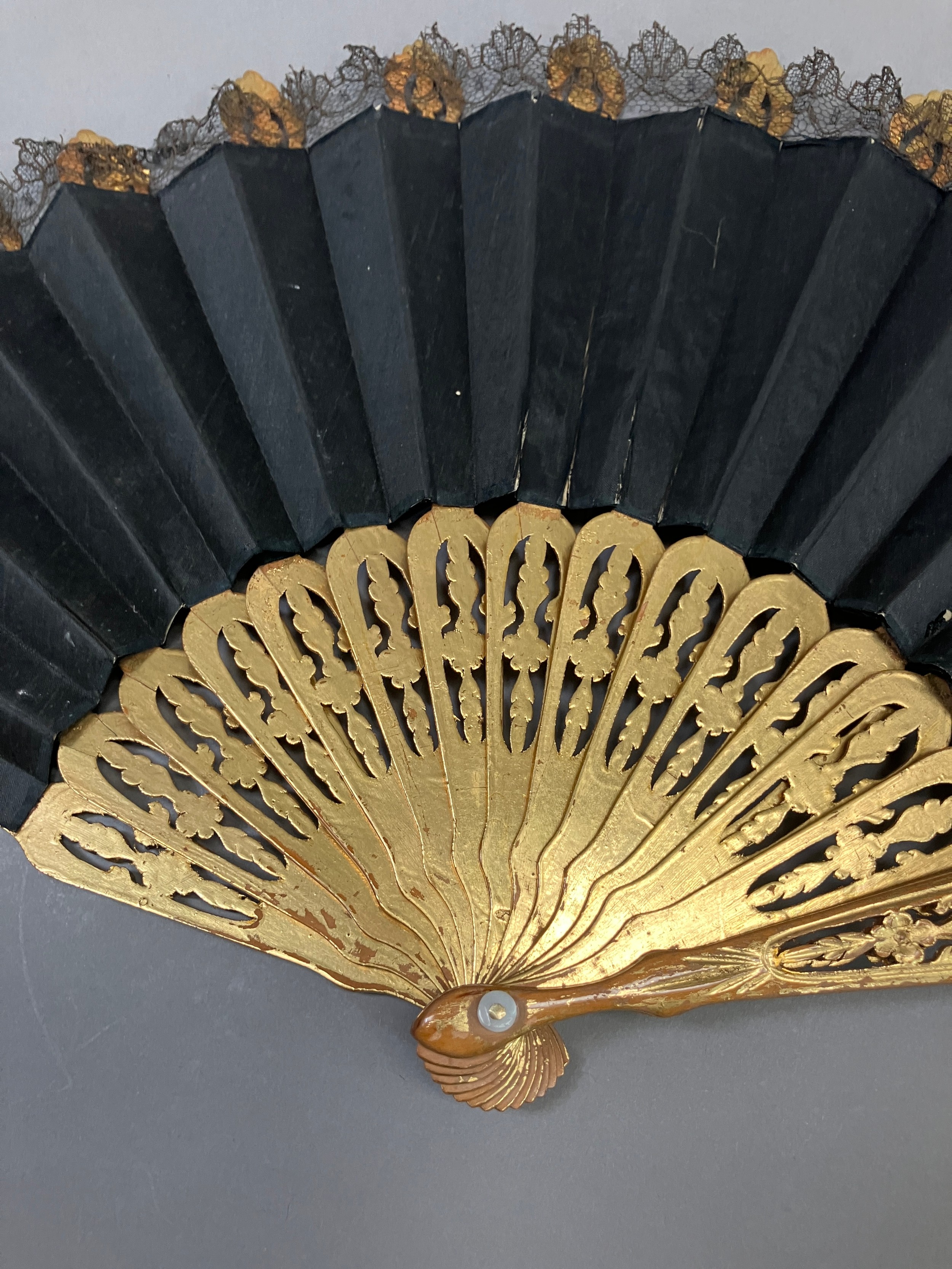 A wood fan, the monture carved and pierced, painted gold, c 1870’s, the black silk satin leaf with - Image 4 of 5