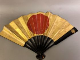 A Japanese war fan, with central feature, the hinomaru, or sun-disk shown in red on a gold-leaf