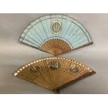 Two late 18th century wood fans, the first a brisé with rounded tips, pierced, with applied