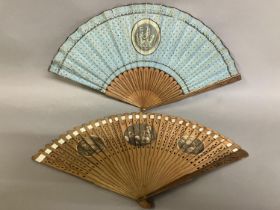 Two late 18th century wood fans, the first a brisé with rounded tips, pierced, with applied