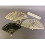 An Art Nouveau fan, the monture of bone, shaped and gilded, the silk leaf painted with a lady in a