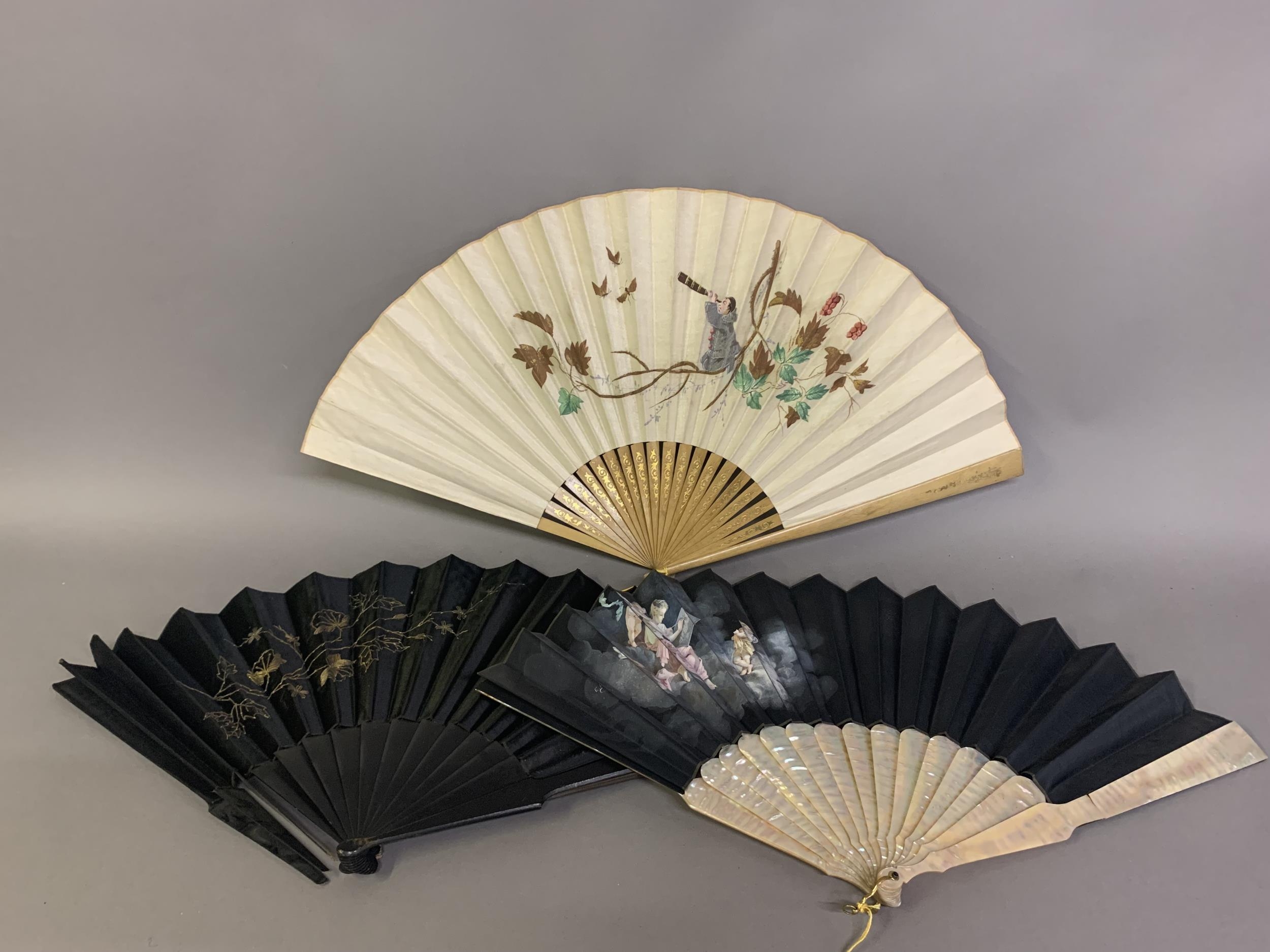 Three fans from the 1890’s: a large wood fan with cream cotton leaf, painted with Pierrot kneeling