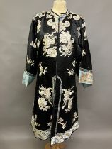 A late 19th c/early 20th century Chinese silk robe, black with applied shaped cloud collar,
