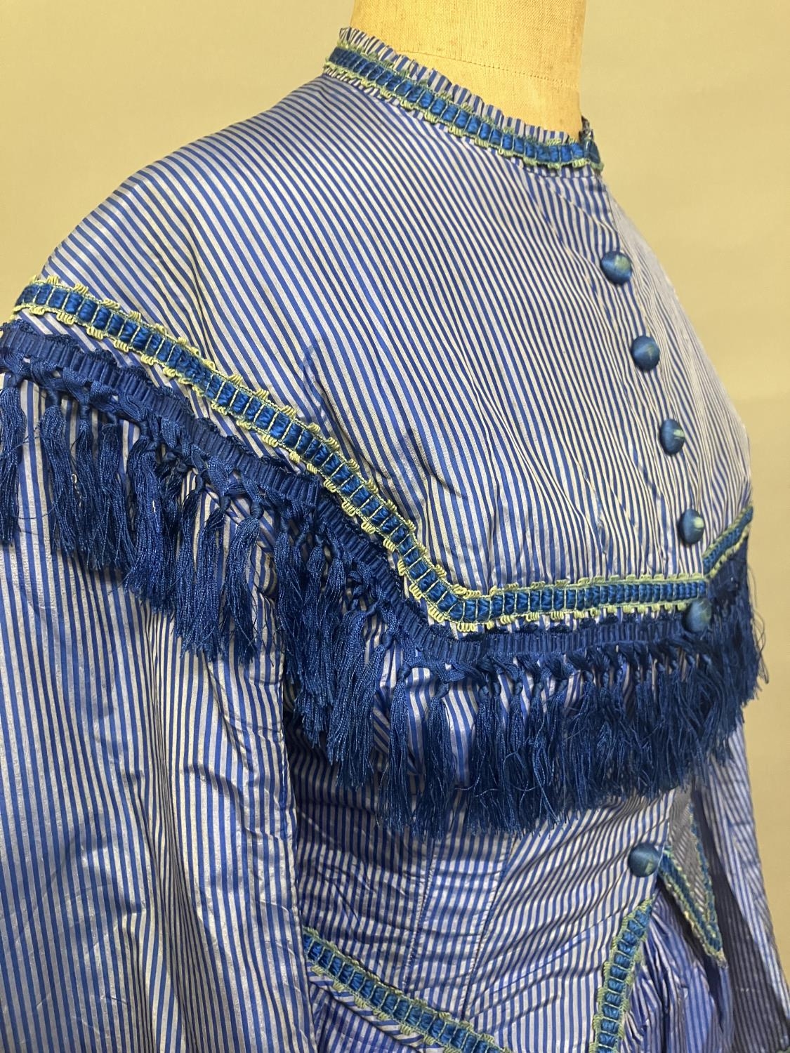 C 1865, a striped blue silk two-piece ensemble, short bodice with rear detail, trimmed with - Image 7 of 8