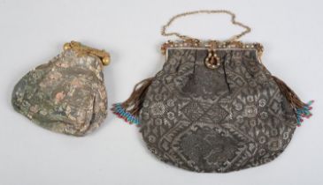 Two early 20th century lamé evening bags, the first with elaborate metal frame inset with stones,