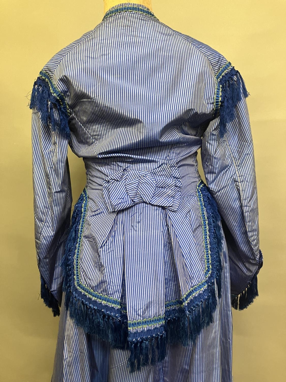 C 1865, a striped blue silk two-piece ensemble, short bodice with rear detail, trimmed with - Image 5 of 8