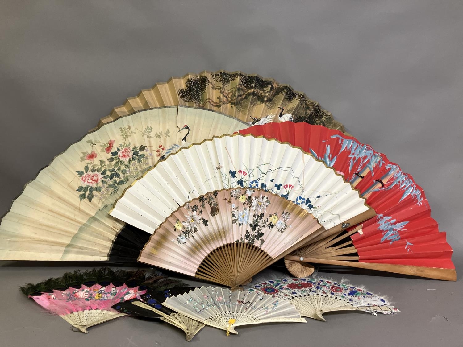 Oriental fans: A selection of folding fans to include 3 Chinese feather fans mounted on pierced