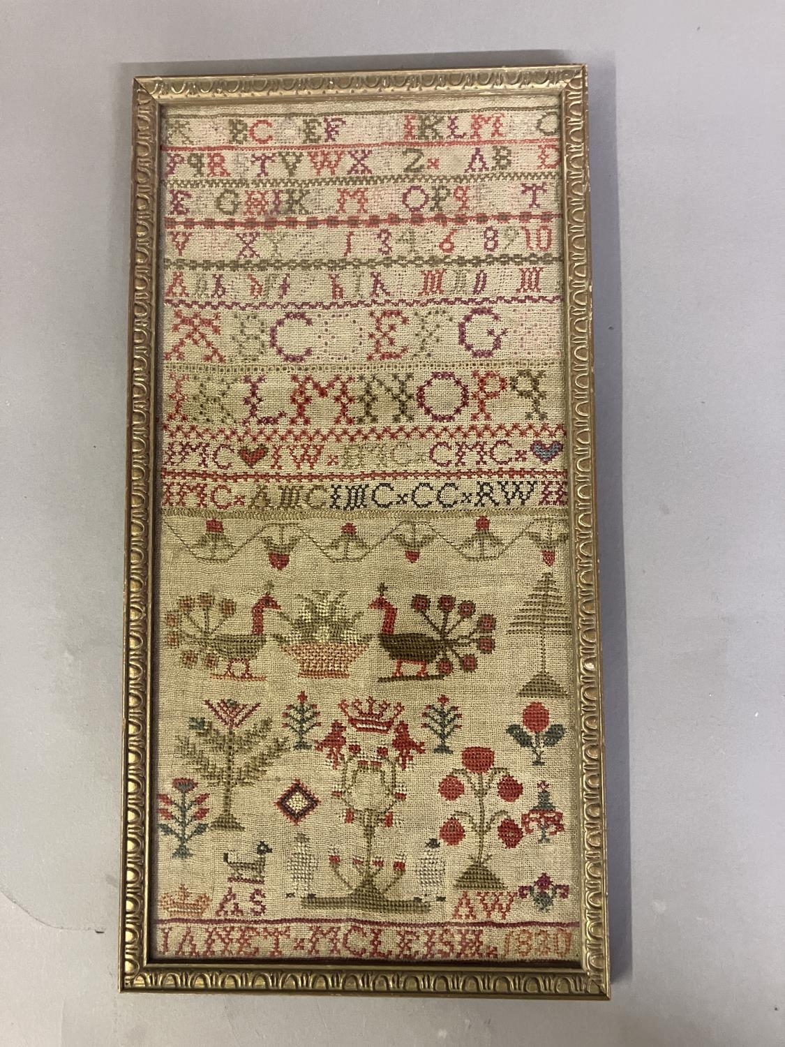 A 19th century needlework sampler worked in bands of the alphabet, some in the Scottish embroidery