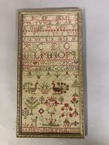 A 19th century needlework sampler worked in bands of the alphabet, some in the Scottish embroidery